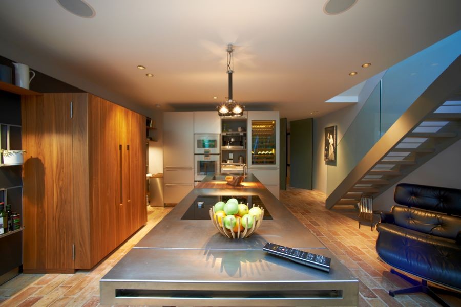 a well-lit kitchen with a hand-held remote device on the counter.