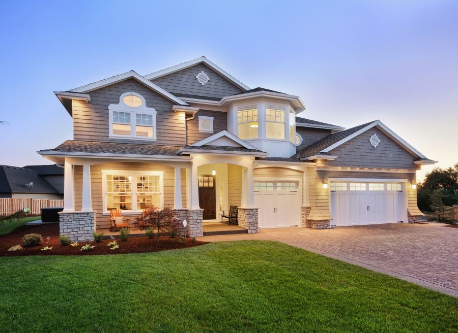 A well-lit home at dusk.