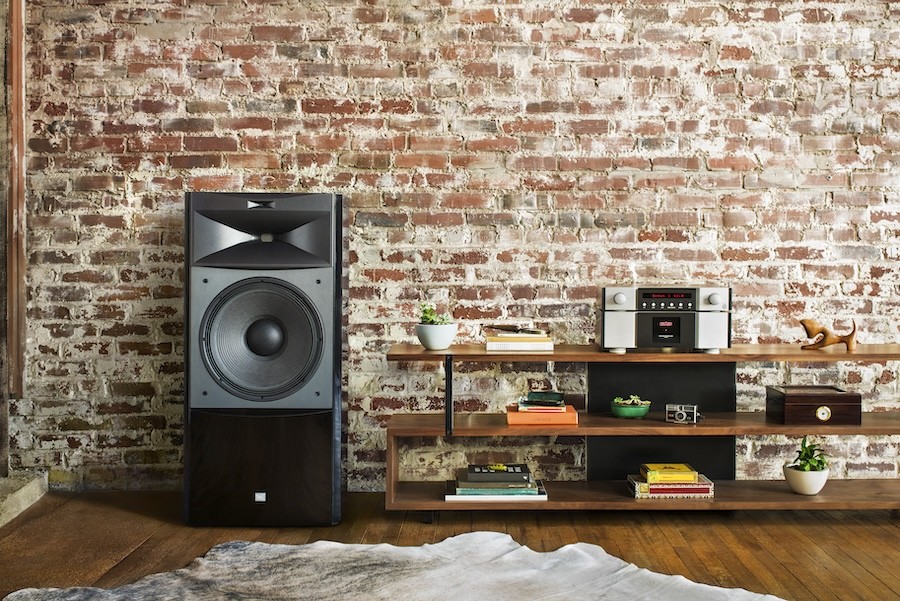A floorstanding JBL loudspeaker next to a wall.